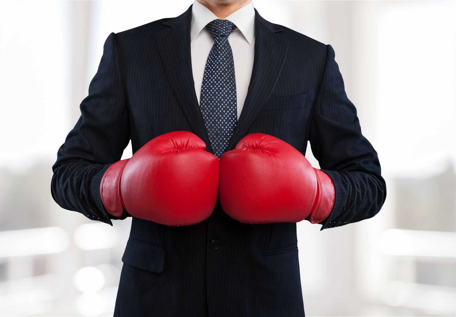 Man in a business suit and boxing gloves