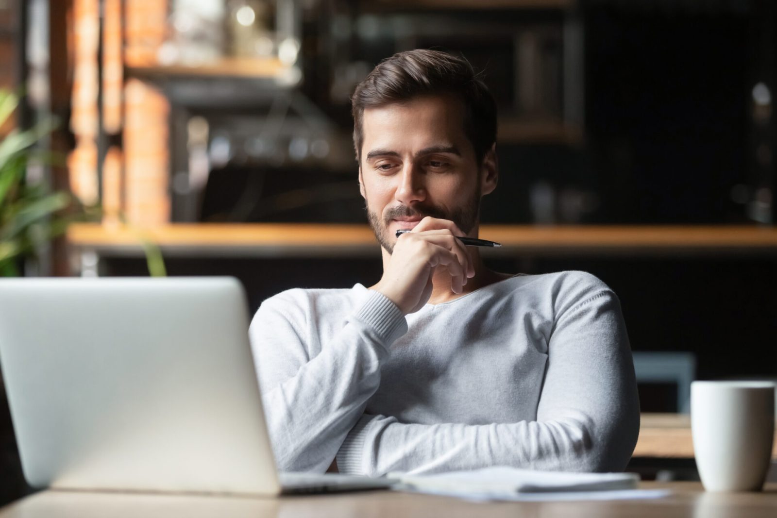 Man at laptop thinking