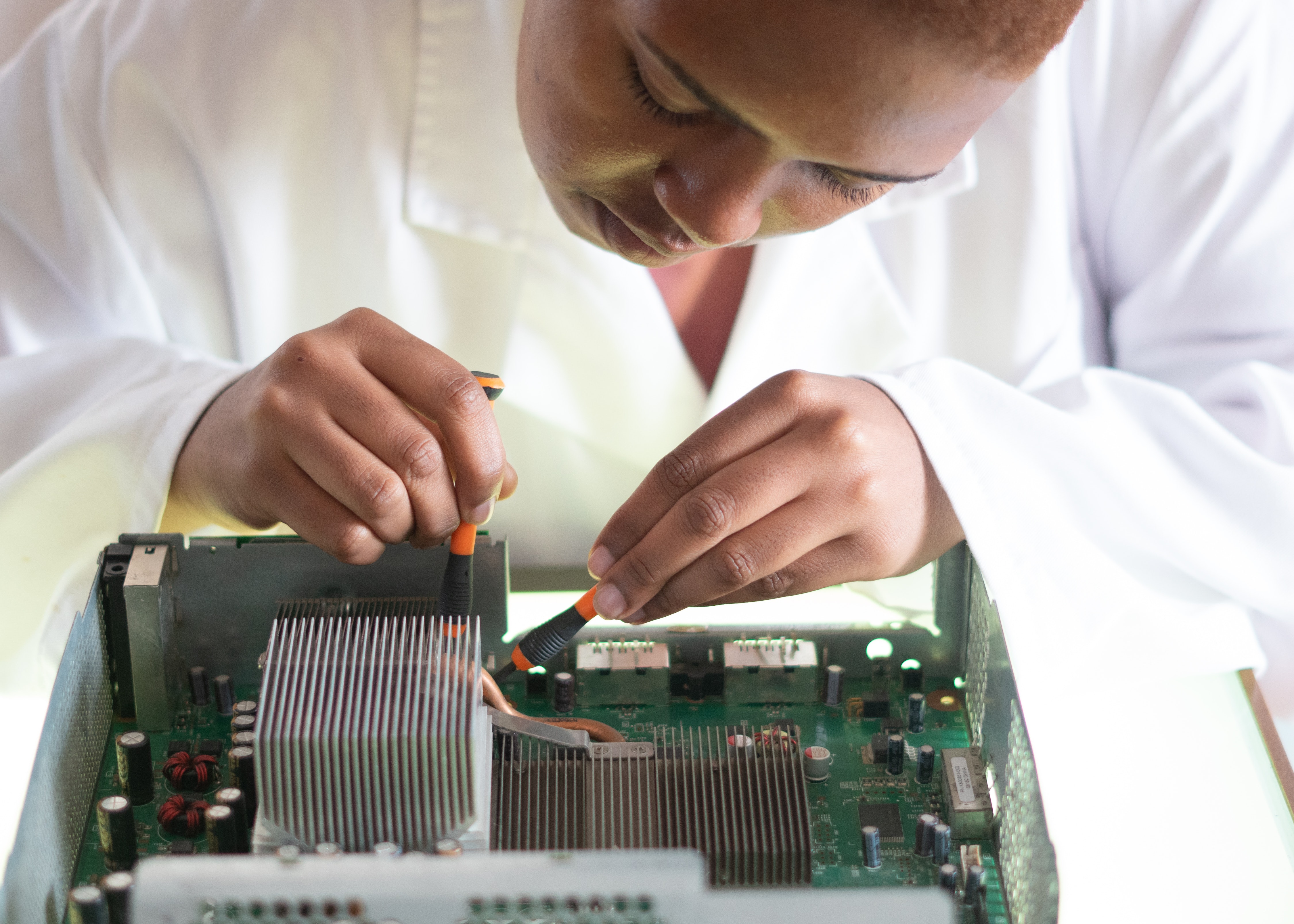 Woman engineer working on motherboard