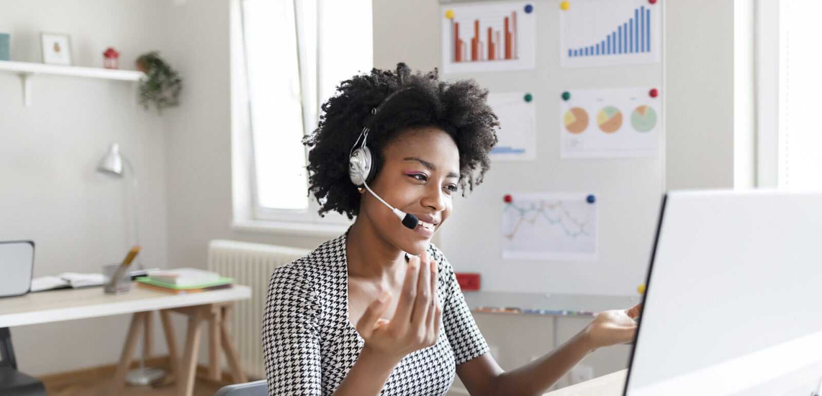 Young woman wearing headphones on a call