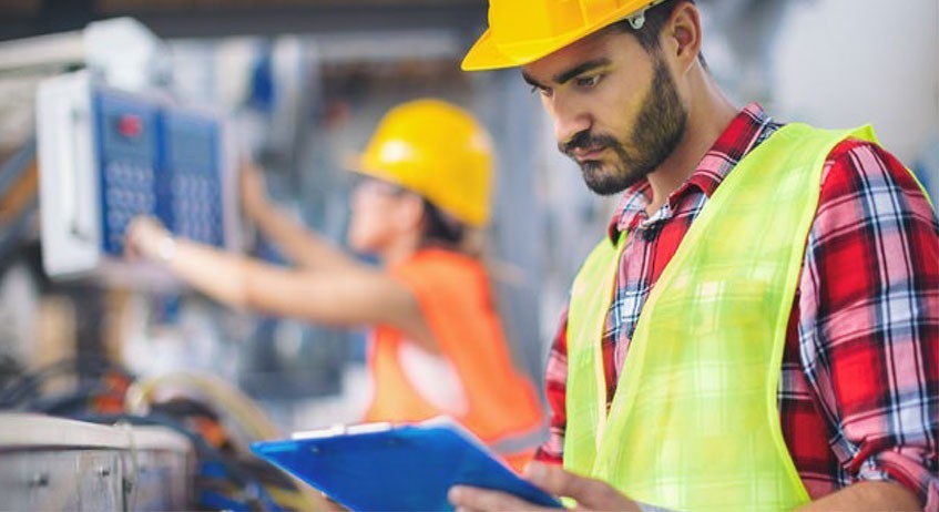 Workers in hard-hats and high-visibility vests
