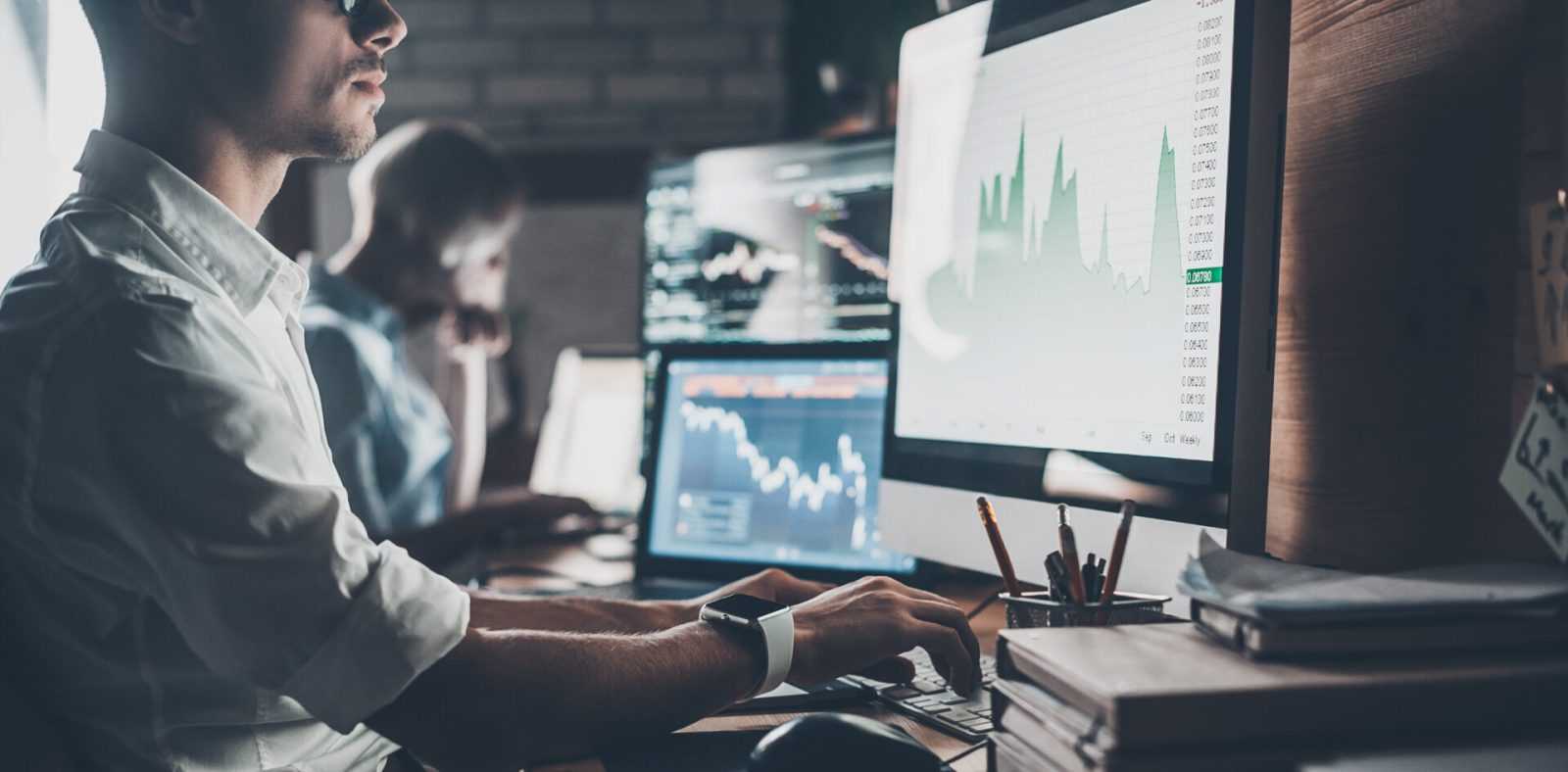 Office workers performing business analysis using computer graphs