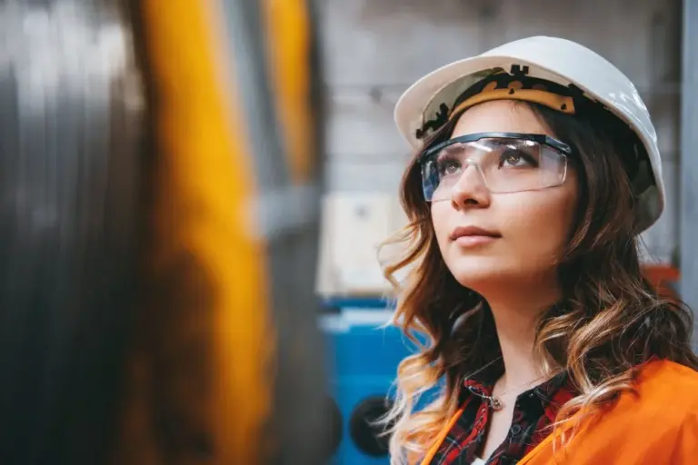 Woman in hard hat and high visibility vest
